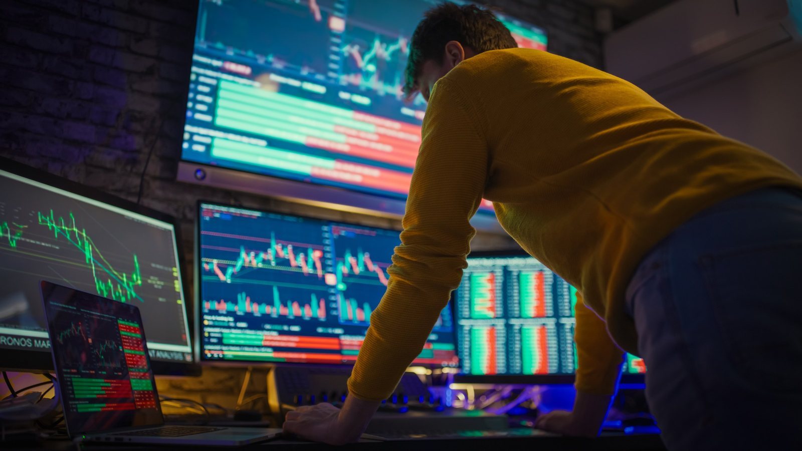 An analyst monitoring market data across trading screens